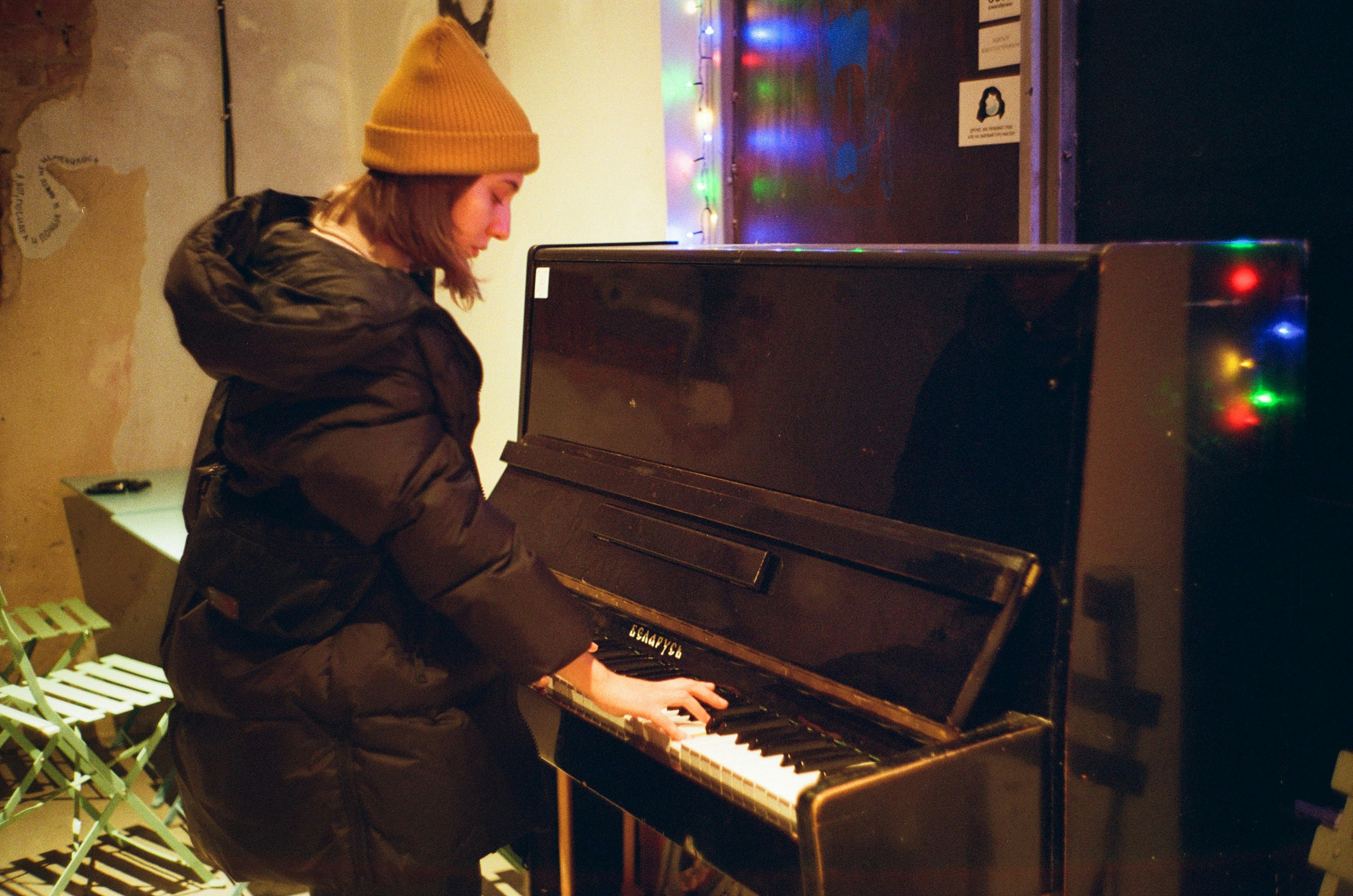 man in black jacket playing piano